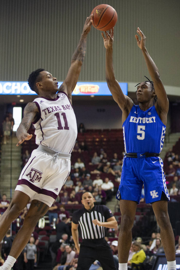 Texas A&M guard Wendell Mitchell (11) blocks a shot attempt by Kentucky guard Immanuel Quic ...