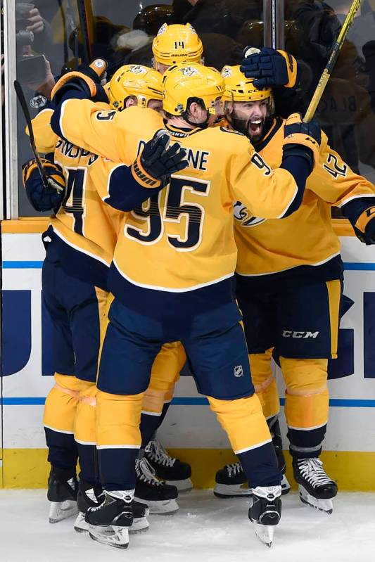 Nashville Predators center Mikael Granlund (64), of Finland, left, celebrates with Colin Blackw ...