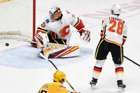 A shot by Nashville Predators center Mikael Granlund (64), of Finland, gets past Calgary Flames ...
