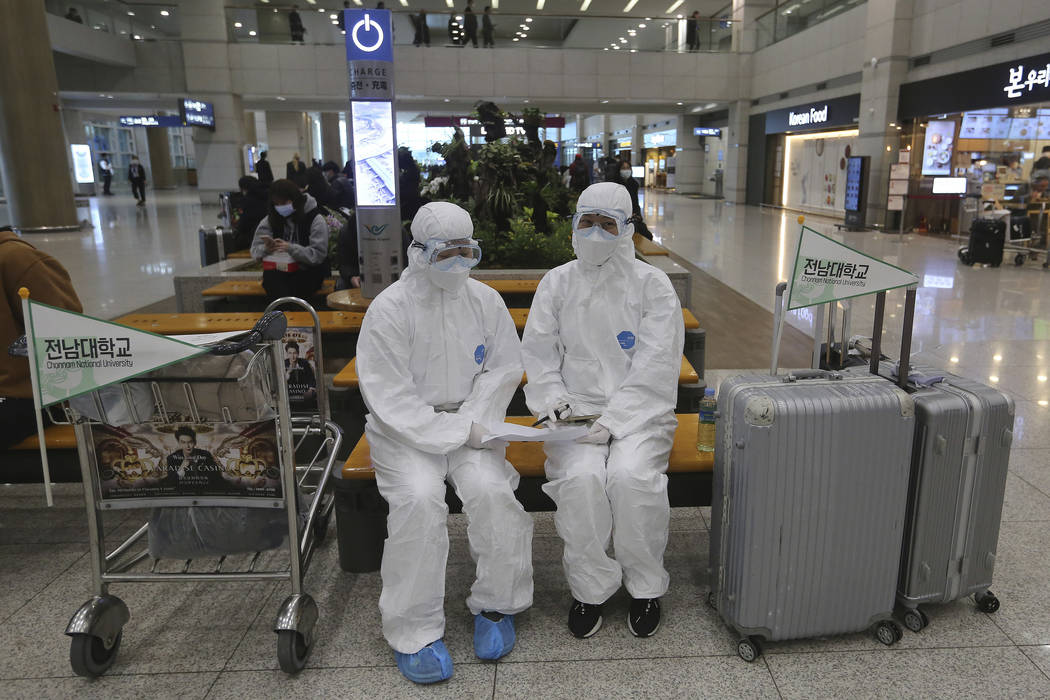 Chonnam National University staff wearing protective attire are on standby for special transpor ...