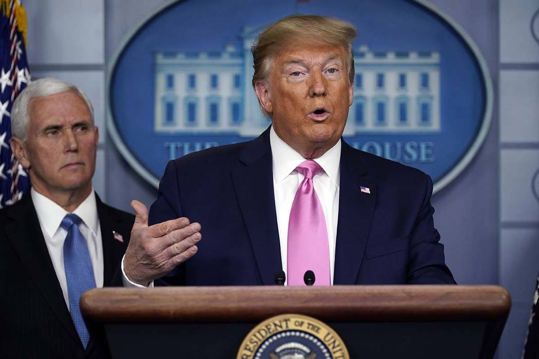 President Donald Trump speaks as Vice President Mike Pence listens during a news conference abo ...