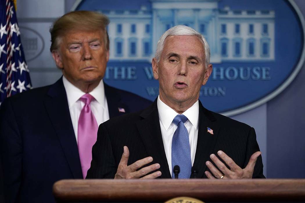 President Donald Trump listens as Vice President Mike Pence speaks during a news conference abo ...