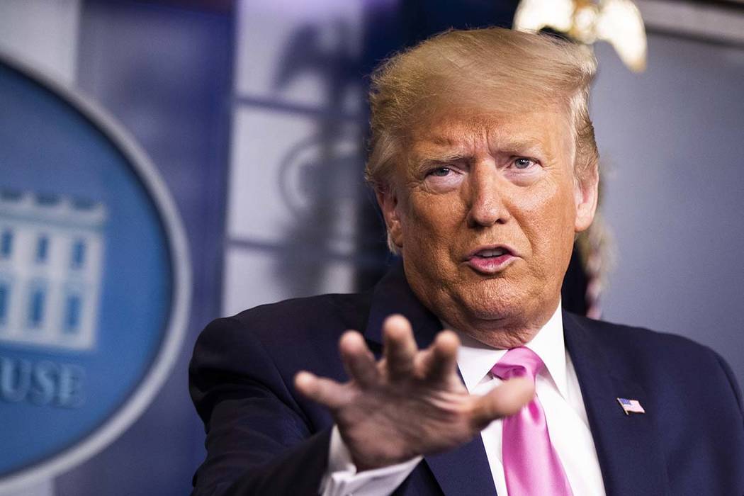 President Donald Trump with members of the president's coronavirus task force speaks during a n ...