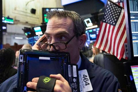 Trader Gregory Rowe works at the New York Stock Exchange, Wednesday, Dec. 12, 2018, in New York ...