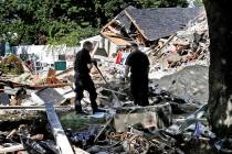 FILE - In this Sep. 21, 2018, file photo, fire investigators pause while searching the debris a ...