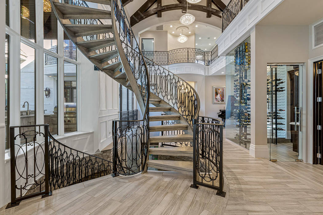 The home features a dramatic spiral staircase with custom ironwork. (Ivan Sher Group)