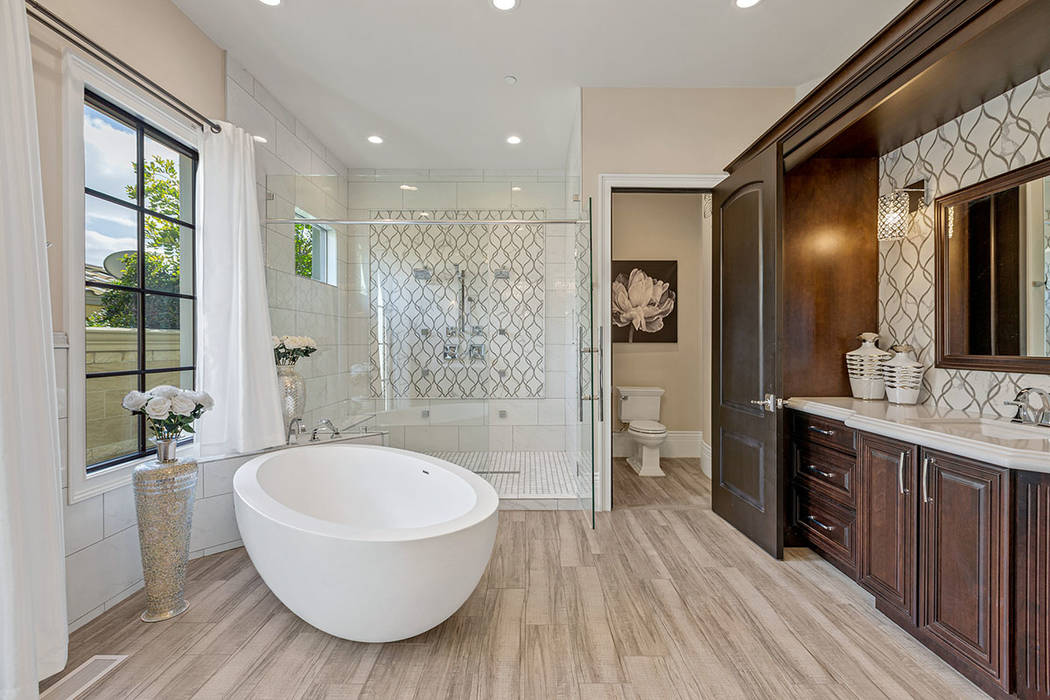 The master bath features an oval soaking tub. (Ivan Sher Group)