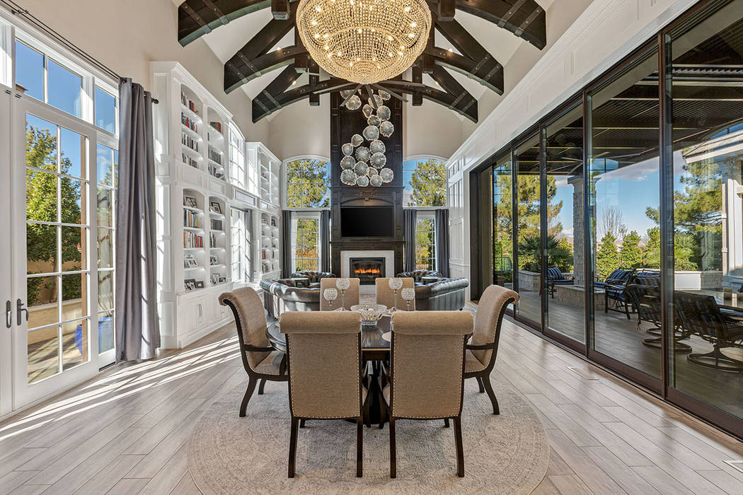 A traditional fireplace and crystal chandelier are centerpieces of the formal dining room. (Iva ...