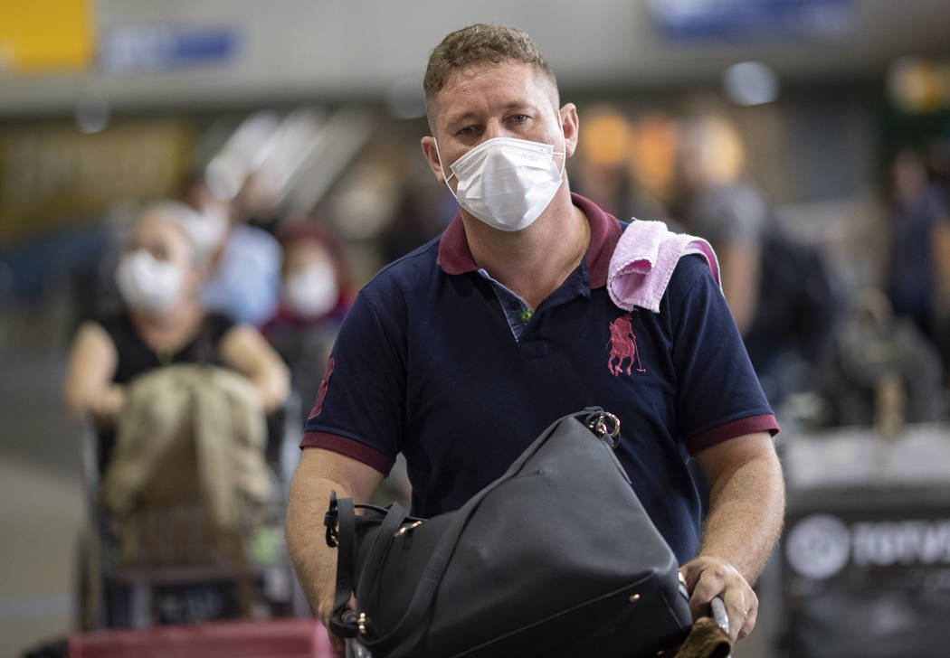 A man wears a mask as a precaution against the spread of the new coronavirus COVID-19 after his ...