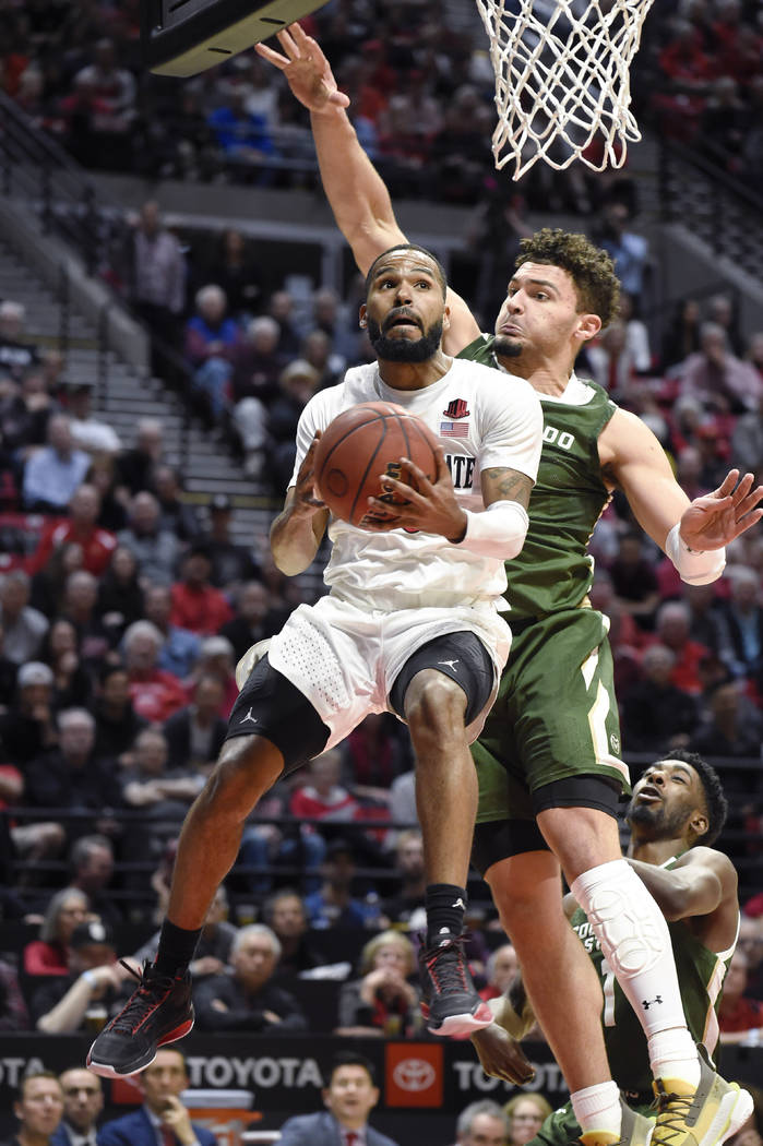 San Diego State guard KJ Feagin (10) drives to the basket past Colorado State guard David Roddy ...