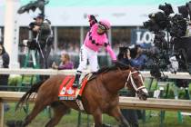 Luis Saez rides Maximum Security, and celebrates after crossing the finish line first during th ...