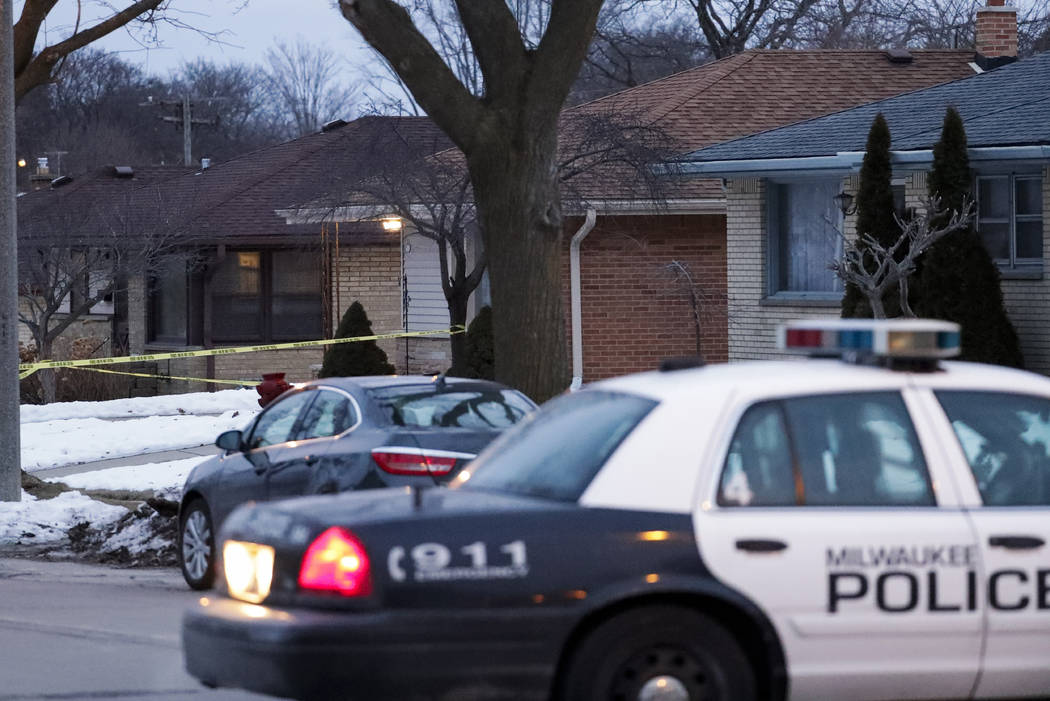 Police are seen outside of a house near Potomac and Courtland after a shooting at Molson Coors, ...