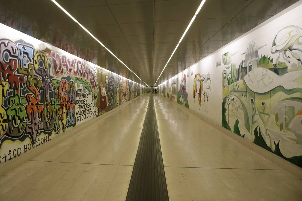 Murals adorn the walls of an empty subway station, in Milan, Friday, Feb. 28, 2020. Due to the ...