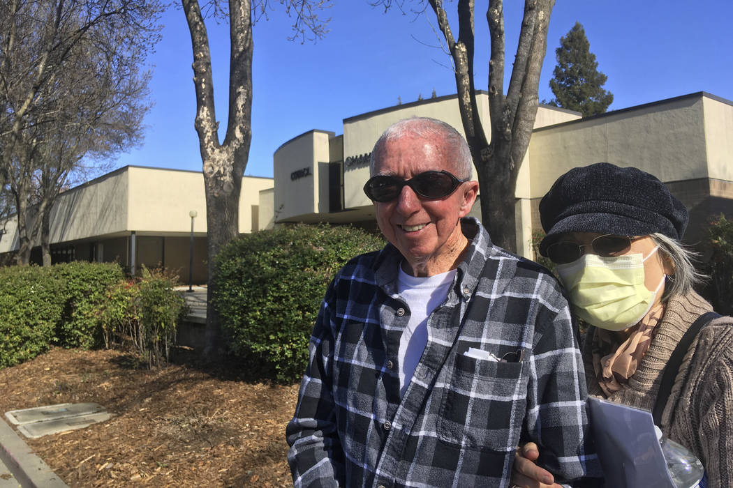Eugenia Kendall, right, wears a mask outside of the Vacaville City Hall while standing with her ...