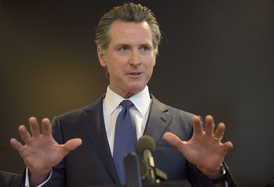 California Governor Gavin Newsom speaks to members of the press at a news conference in Sacrame ...