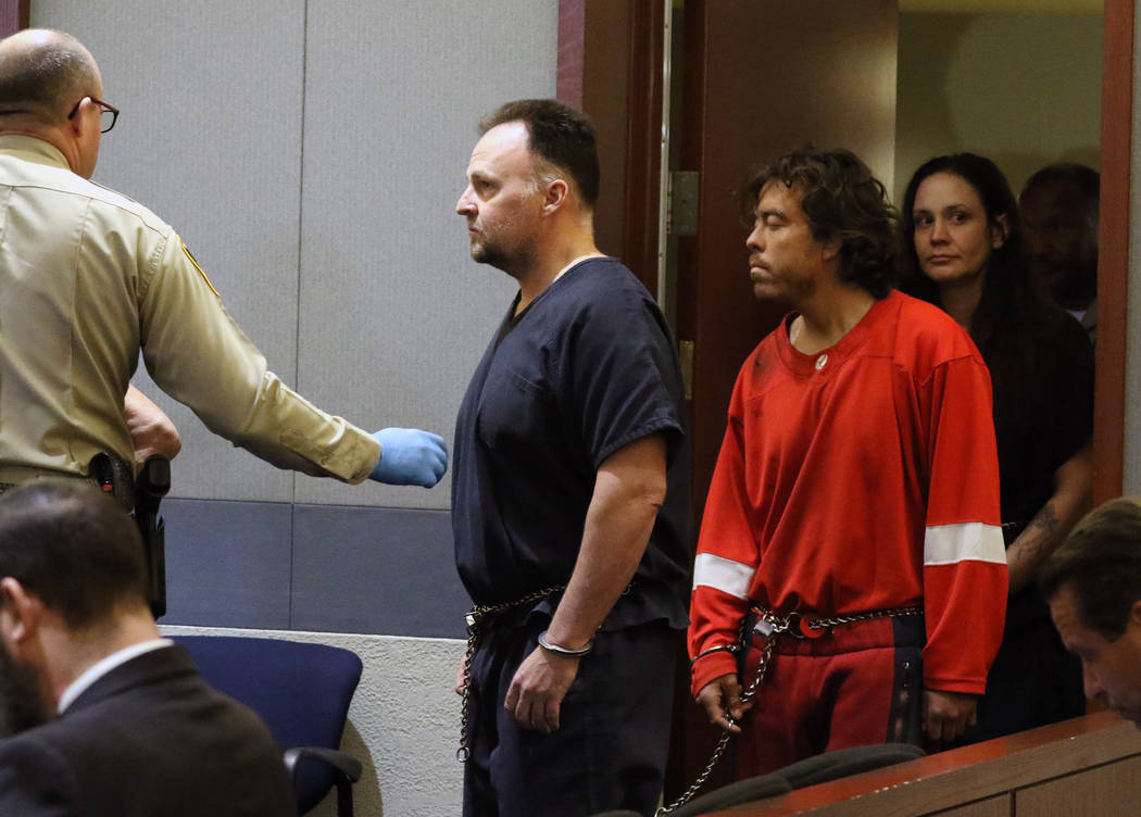 Former Las Vegas police officer Christopher Peto, 47, center, is led into the courtroom during ...