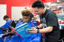 Barber student Tristian de Guzman reads to Nicholas Lewis, 12, during the third annual "Re ...