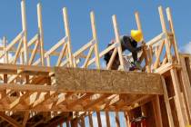 A worker constructs a house near the corner of Mesa Park Drive and Hualapai Way in the Summerli ...
