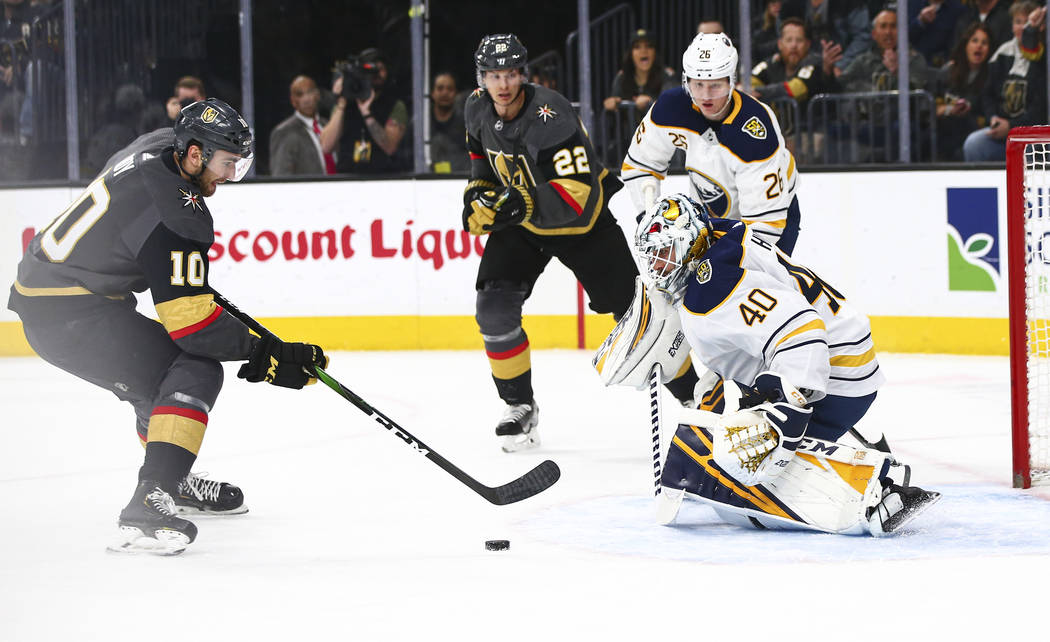 Golden Knights' Nic Roy (10) skates with the puck right before sending it past Buffalo Sabres g ...