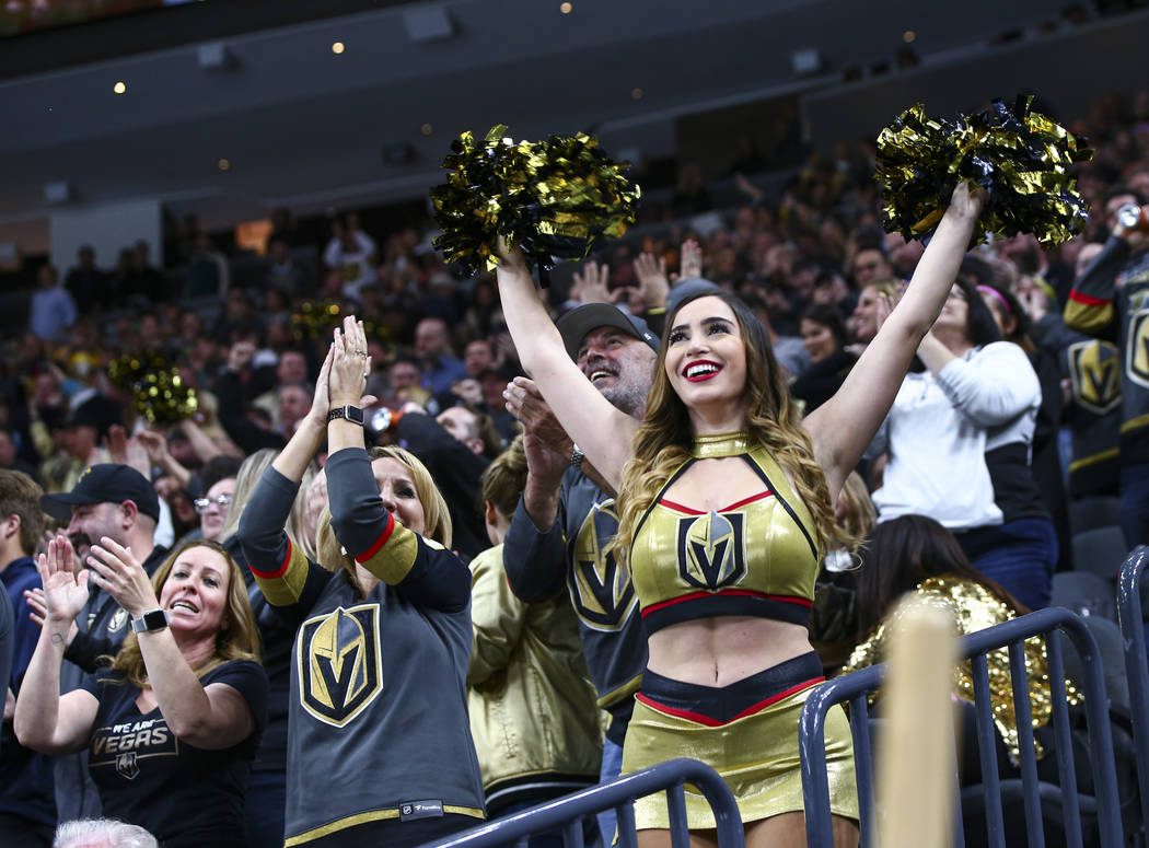A Golden Knights cheerleader celebrates a goal by Golden Knights' Nic Roy, not pictured, during ...