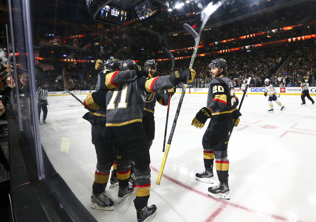 Golden Knights' William Karlsson (71) celebrates with teammates after scoring against the Buffa ...
