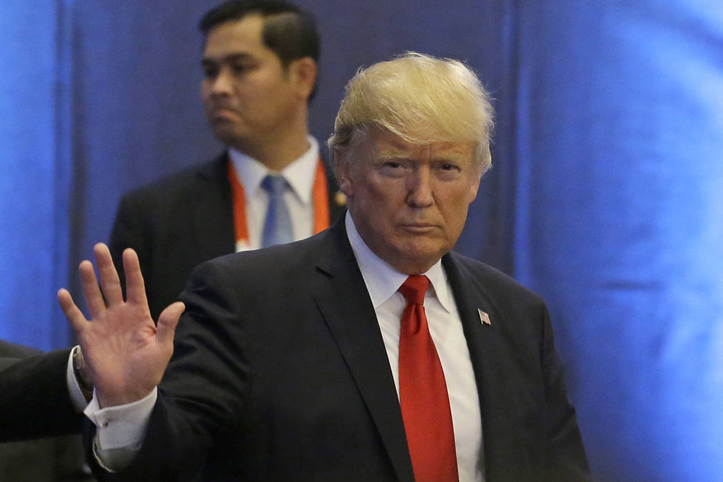 President Donald Trump waves as he arrives during the ASEAN-U.S. Summit on Monday, Nov. 13, 201 ...