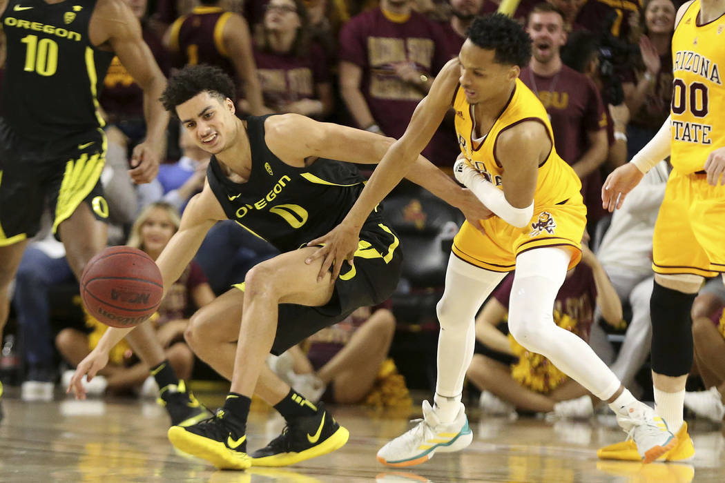 Oregon's Will Richardson (0) battles for a loose ball with Arizona State's Alonzo Verge (11) du ...