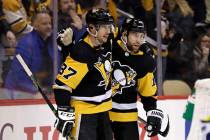 Pittsburgh Penguins' Jason Zucker (16) celebrates his goal with Sidney Crosby (87), who assiste ...