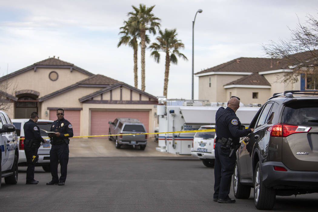 An officer speaks to someone who lives in the taped off scene of an "officer-involved&quot ...