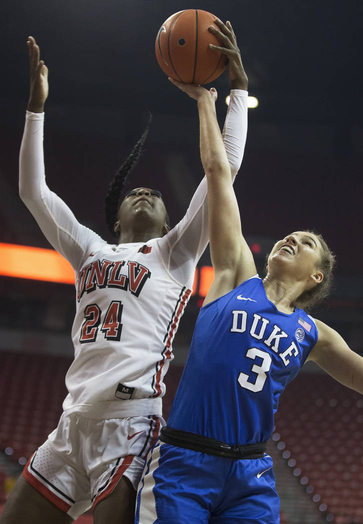 UNLV Lady Rebels guard Rodjanae Wade (24) fights for a rebound with Duke Blue Devils guard Miel ...