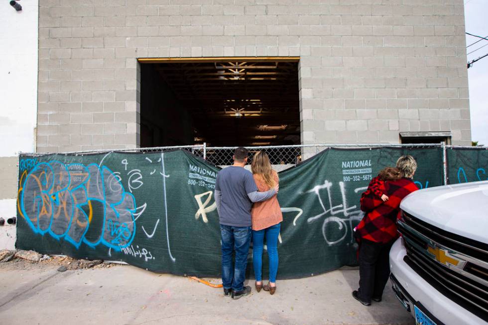 Jason and Lauren Taylor peek at the space where their brewery will be. (Chase Stevens)