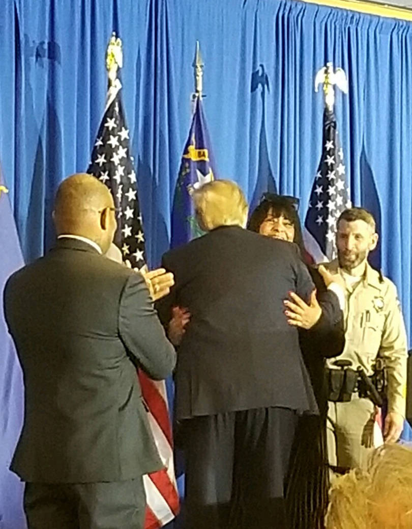 President Donald Trump embraces Lois Hockersmith on Feb. 20; surrounding them are Metro Police ...