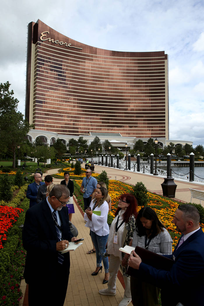 Members of the news media take a tour on the Harbor Walk outside Encore Boston Harbor in Everet ...