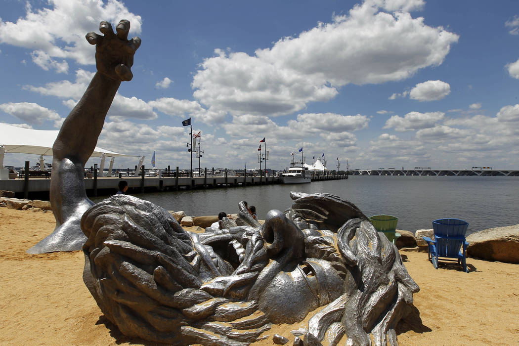 "The Awakening" sculpture is seen in the sand in the National Harbor Friday, June 15, 2012 in O ...