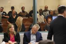 Suspects sit behind a partition glass during their initial appearance at the Regional Justice C ...