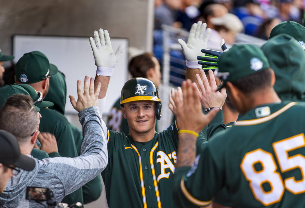 Oakland Athletics infielder Matt Chapman (26) helps celebrate their first run versus the Clevel ...