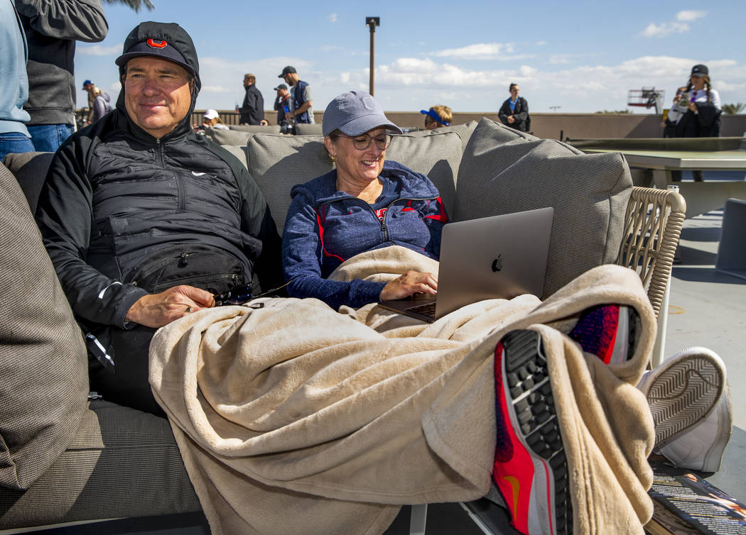 Val, left, and Jenne Hunter of Alpine, Utah, stay warm on a right field couch as the Cleveland ...