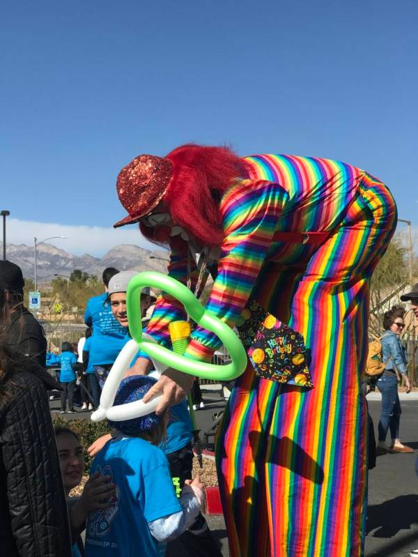 Charlie the Clown makes balloon crowns for children during Walk4Friendship at Bet Yossef Commun ...