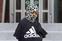 Dantiaja Almanzar, 2, bundled up as he exits the Regional Justice Center during windy morning o ...