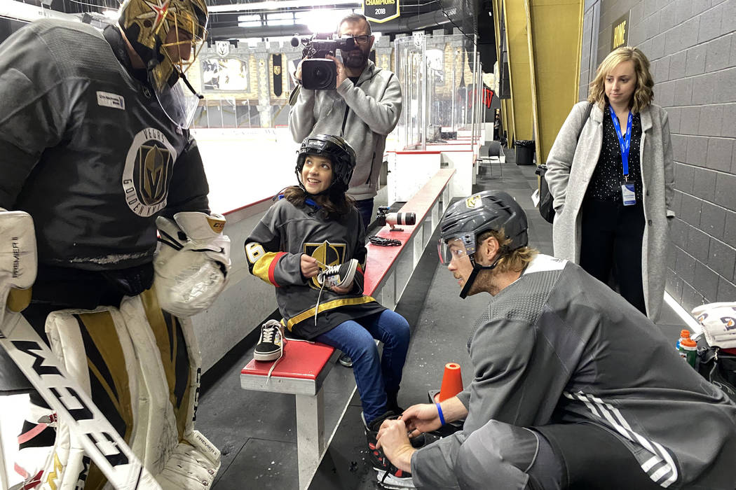 Make-A-Wish kid Sydney Lilore, 10, of Las Vegas, is helped by Vegas Golden Knights defenseman J ...