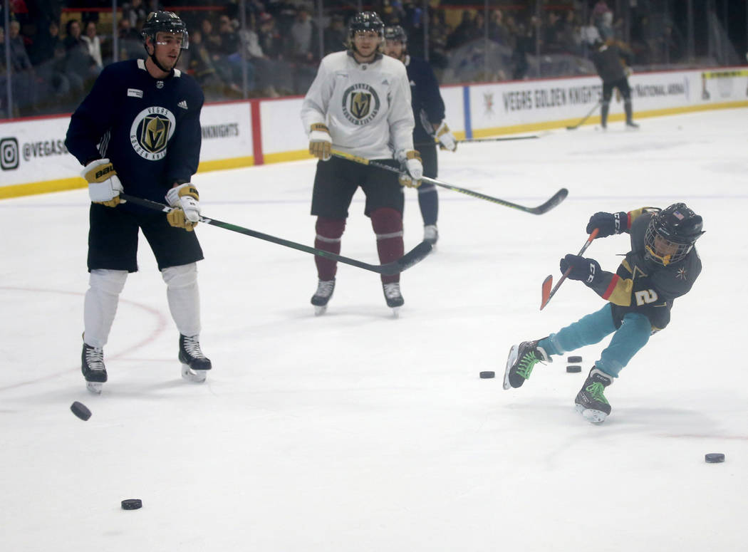 Make-A-Wish kid Arjun Jain, 12, of Somerset, N.J. shoots in front of Vegas Golden Knights right ...