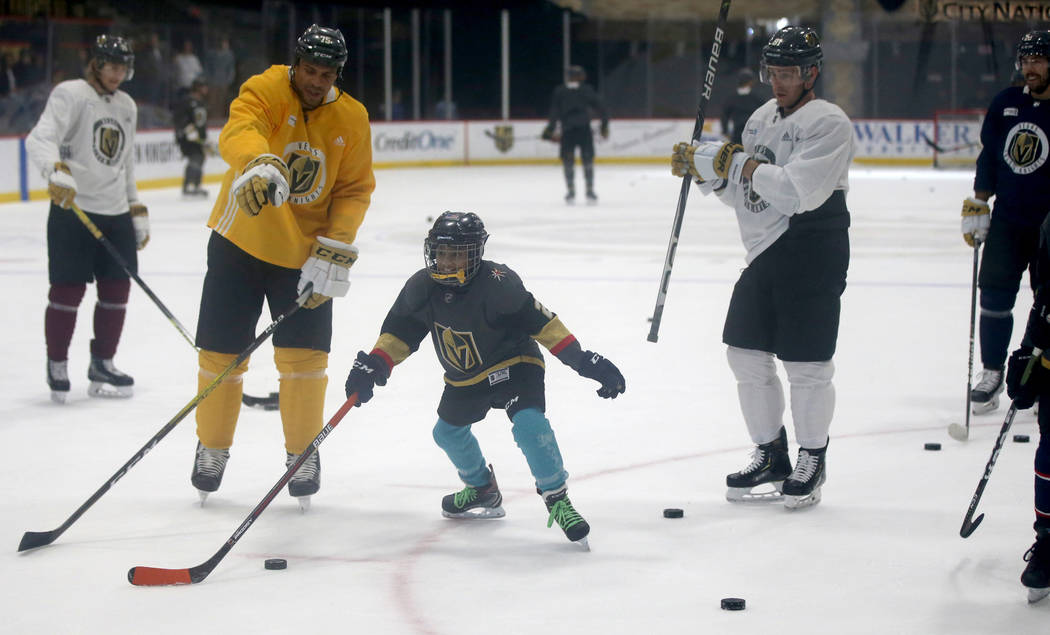 Make-A-Wish kid Arjun Jain, 12, of Somerset, N.J. skates with Golden Knights players right ...