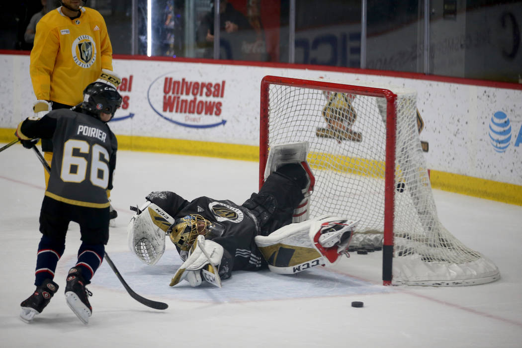 Make-A-Wish kid Jerome Poirier, 13, of Canada, shoots on Vegas Golden Knights goaltender Marc-A ...