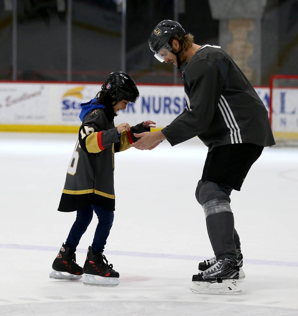 Make-A-Wish kid Sydney Lilore, 10, of Las Vegas, skates with Vegas Golden Knights defenseman Jo ...