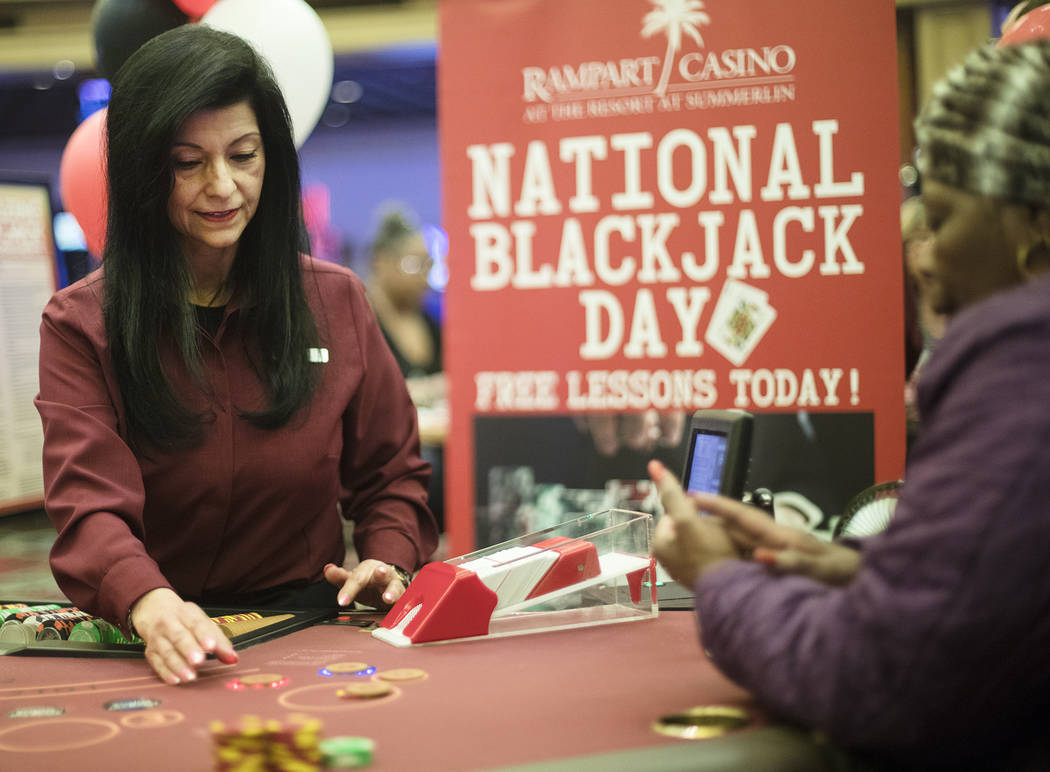 Izzy, a blackjack dealer, deals for Barbara Wright, right, of Las Vegas, at Rampart Casino in L ...