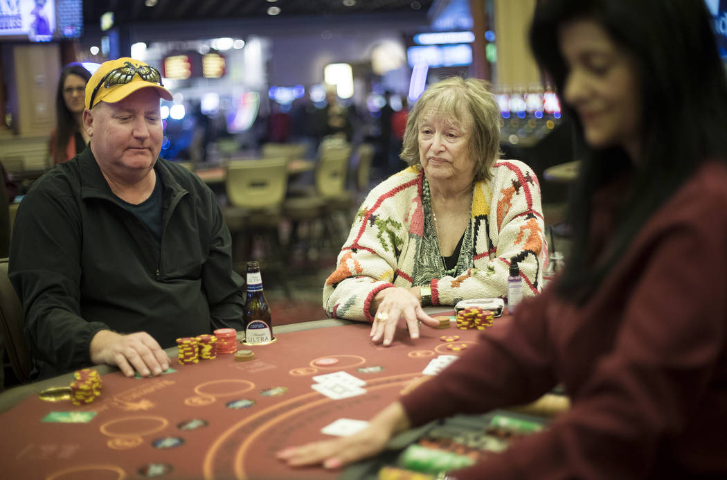 Jeff Siegrist, left, of Illinois, plays blackjack with Karen Allison, right, of Las Vegas, at R ...