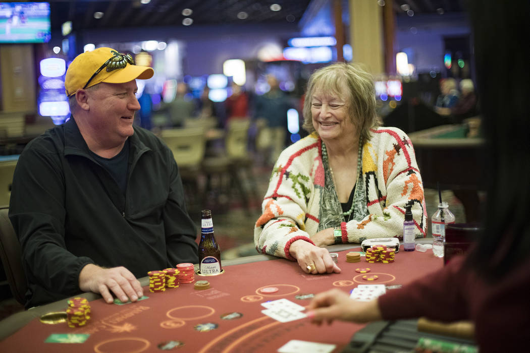 Jeff Siegrist, left, of Illinois, plays blackjack with Karen Allison, right, of Las Vegas, at R ...