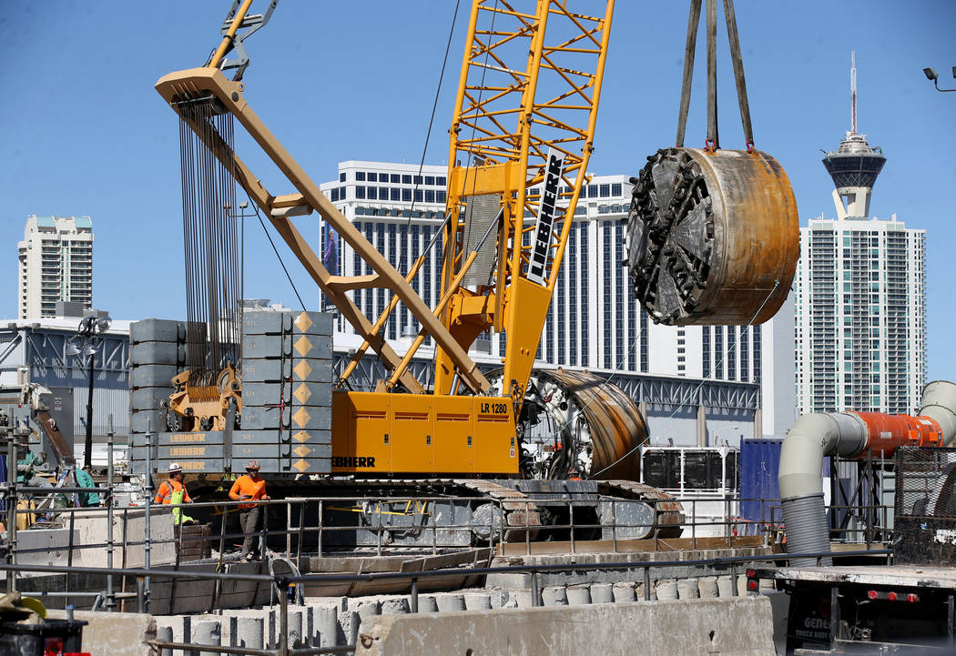 The Boring Co. workers lower a piece of the drill assembly to begin work on the second tunnel i ...