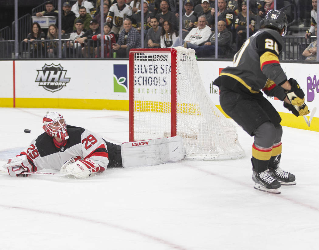 New Jersey Devils goaltender Mackenzie Blackwood (29) makes a diving save against Vegas Golden ...