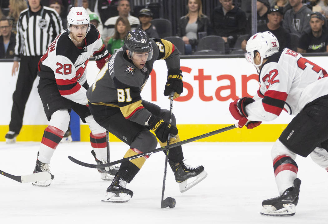 Vegas Golden Knights center Jonathan Marchessault (81) tries to skate around New Jersey Devils ...